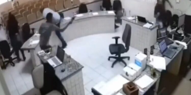 Imagens mostram quando atirador se levanta e vai em direção ao réu