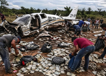 Moradores correram e pegaram parte do dinheiro espalhado após o impacto